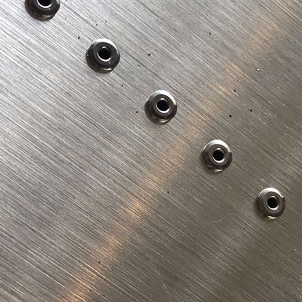 Detail of rivets in brushed stainless steel panel