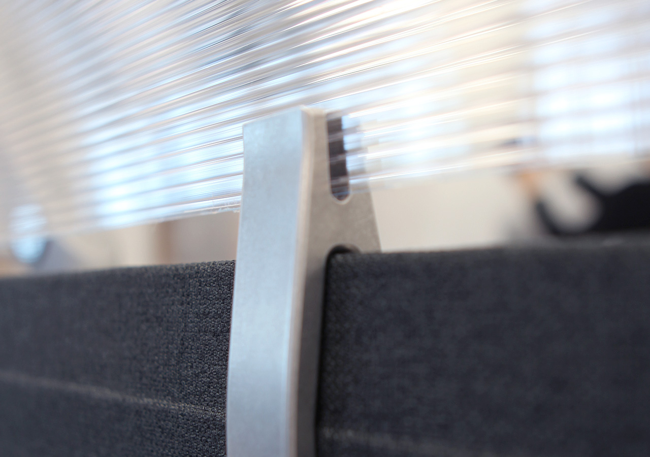 Detail of tuning fork shaped custom aluminum hardware holding plexiglass in place