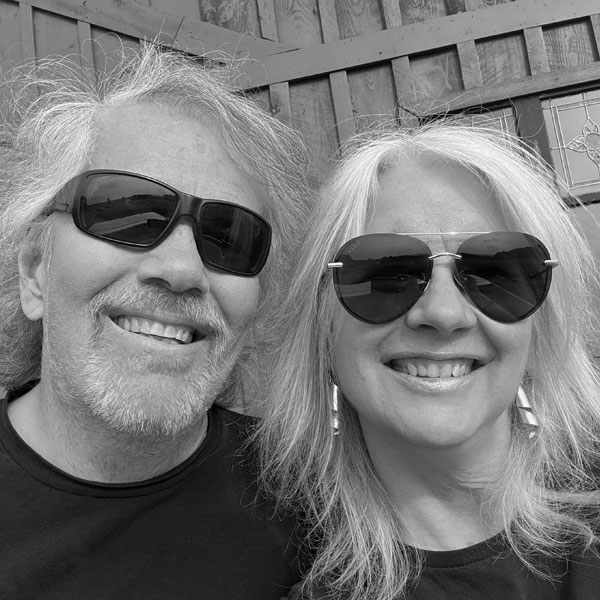 Robin and Kim Cox sitting together and smiling.